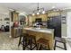 Kitchen with wood cabinets, stainless steel appliances, and an island with seating at 911 Centennial Rd, Martinsville, IN 46151
