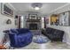 Living room with a stone fireplace, hardwood floors, and blue furniture at 911 Centennial Rd, Martinsville, IN 46151