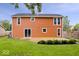 Large backyard with a wooden deck, privacy fence, and plenty of green space at 9385 Helmsdale Dr, Indianapolis, IN 46256