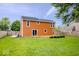 Large backyard with a wooden deck, privacy fence, and plenty of green space at 9385 Helmsdale Dr, Indianapolis, IN 46256