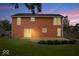 Backyard view with a wooden deck, grassy area, and charming exterior of the two-story home at 9385 Helmsdale Dr, Indianapolis, IN 46256