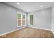 Serene bedroom filled with light from two windows and featuring wood flooring at 9385 Helmsdale Dr, Indianapolis, IN 46256