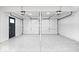 Spacious two-car garage with epoxy flooring and ample space for parking and storage at 9385 Helmsdale Dr, Indianapolis, IN 46256