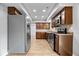 Modern kitchen features stainless steel appliances, wood cabinets, and attractive backsplash at 9385 Helmsdale Dr, Indianapolis, IN 46256