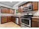 Updated kitchen featuring stainless steel appliances, wood cabinets, and modern countertops at 9385 Helmsdale Dr, Indianapolis, IN 46256