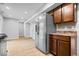 Open kitchen features stainless steel appliances and wood cabinets with modern flooring at 9385 Helmsdale Dr, Indianapolis, IN 46256