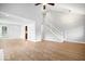Open living room features wood floors, a staircase, and modern lighting fixtures at 9385 Helmsdale Dr, Indianapolis, IN 46256