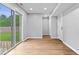 Bright room features wood floors and sliding glass doors to the outside at 9385 Helmsdale Dr, Indianapolis, IN 46256