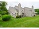 Expansive backyard featuring a green lawn, mature trees, and manicured landscaping at 9477 Aberdare N Dr, Indianapolis, IN 46250