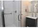 This bathroom features a glass enclosed shower, a vanity with a mirror, and white subway tile at 9477 Aberdare N Dr, Indianapolis, IN 46250