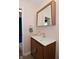 Bathroom with floating wood vanity, modern faucet, mirror, and tile flooring at 9477 Aberdare N Dr, Indianapolis, IN 46250