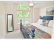 A bedroom features a large window, a blue four poster bed, and a full length mirror at 9477 Aberdare N Dr, Indianapolis, IN 46250