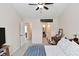 The bedroom has neutral walls and carpet, a ceiling fan, and access to the bathroom and hallway at 9477 Aberdare N Dr, Indianapolis, IN 46250