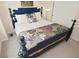 A bedroom features a blue four poster bed with decorative pillows and bedding at 9477 Aberdare N Dr, Indianapolis, IN 46250