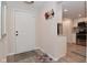 Inviting entryway with coat hooks, leading to an open kitchen with stainless steel appliances and updated finishes at 9477 Aberdare N Dr, Indianapolis, IN 46250
