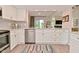 Bright updated kitchen features stainless steel appliances and white cabinets with backyard view at 9477 Aberdare N Dr, Indianapolis, IN 46250
