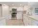 Bright kitchen featuring stainless steel appliances, white cabinets, and quartz countertops and stylish backsplash at 9477 Aberdare N Dr, Indianapolis, IN 46250