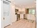 Updated kitchen with modern stainless-steel appliances, white cabinets, and in-unit laundry at 9477 Aberdare N Dr, Indianapolis, IN 46250