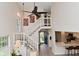Bright open-concept living room features staircase, views of the kitchen, and lots of natural light at 9477 Aberdare N Dr, Indianapolis, IN 46250