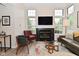 Inviting living area with a fireplace, large windows and neutral decor at 9477 Aberdare N Dr, Indianapolis, IN 46250