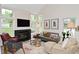 Bright living room features a cozy fireplace, vaulted ceilings and ample natural light at 9477 Aberdare N Dr, Indianapolis, IN 46250