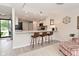 Open-concept living room featuring bar seating, modern kitchen, and backyard access at 9477 Aberdare N Dr, Indianapolis, IN 46250