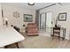 Cozy living room features a reading nook with chair and backyard access via sliding glass door at 9477 Aberdare N Dr, Indianapolis, IN 46250