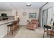 Inviting living room with bar seating, chair, modern decor, and sliding glass door at 9477 Aberdare N Dr, Indianapolis, IN 46250