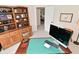 Home office with custom shelving, wooden desk, and lots of display space at 9477 Aberdare N Dr, Indianapolis, IN 46250
