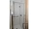 A modern shower features a glass door, subway tile, a shower head, and a grab bar at 9477 Aberdare N Dr, Indianapolis, IN 46250