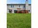 Expansive backyard view showcasing a well-manicured lawn, dual patios and deck perfect for outdoor entertaining at 10601 Adam Dr, Indianapolis, IN 46231