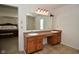 Bathroom with double sinks and an open doorway leading into another bedroom at 10601 Adam Dr, Indianapolis, IN 46231