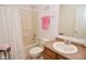 Well-lit bathroom featuring a tub and shower combination with a single sink vanity at 10601 Adam Dr, Indianapolis, IN 46231