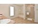Bright bathroom with a walk-in shower, tub, and a single window for natural light at 10601 Adam Dr, Indianapolis, IN 46231