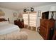Bright bedroom featuring neutral carpet, wood furniture and dual windows at 10601 Adam Dr, Indianapolis, IN 46231