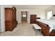 Spacious bedroom with wood furniture, including an armoire, dressers, and bed with bench at 10601 Adam Dr, Indianapolis, IN 46231