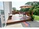 A lovely, wooden deck with chairs, table, umbrella, and foliage, providing a relaxing outdoor space at 10601 Adam Dr, Indianapolis, IN 46231