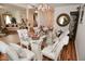 Formal dining area with chandelier, glass table, seating for six, and access to living room at 10601 Adam Dr, Indianapolis, IN 46231