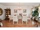 Formal dining area with chandelier, seating for six, wood floors, and decorative accents at 10601 Adam Dr, Indianapolis, IN 46231
