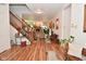 Spacious entryway with wood floors, staircase, and views into the living room at 10601 Adam Dr, Indianapolis, IN 46231