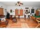 Entertainment room with a piano, pool table, bar stools, and unique decorative elements at 10601 Adam Dr, Indianapolis, IN 46231