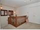 Hallway with wooden railing and two vintage pendant lights and a double door closet at 10601 Adam Dr, Indianapolis, IN 46231