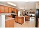 Well-lit kitchen boasting wooden cabinets, a central island, and an adjacent dining area at 10601 Adam Dr, Indianapolis, IN 46231
