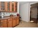 Charming kitchen area featuring wooden cabinets, counter space, and a wine glass rack for a cozy feel at 10601 Adam Dr, Indianapolis, IN 46231