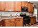 A kitchen featuring wooden cabinets, a gas range, and ample countertop space for cooking at 10601 Adam Dr, Indianapolis, IN 46231
