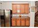 Spacious kitchen featuring stainless steel appliances, wooden cabinets, and adjacent staircase at 10601 Adam Dr, Indianapolis, IN 46231