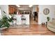 Inviting living room featuring hardwood floors, decorative bar stools, and open access to the kitchen at 10601 Adam Dr, Indianapolis, IN 46231