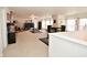 Spacious living room with neutral carpet, ceiling fan, large tv, and dining area at 10601 Adam Dr, Indianapolis, IN 46231