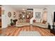 Cozy living room featuring hardwood floors, neutral sofas, and staircase access at 10601 Adam Dr, Indianapolis, IN 46231