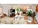 Bright living area featuring a fireplace, hardwood floors, and lots of plants at 10601 Adam Dr, Indianapolis, IN 46231